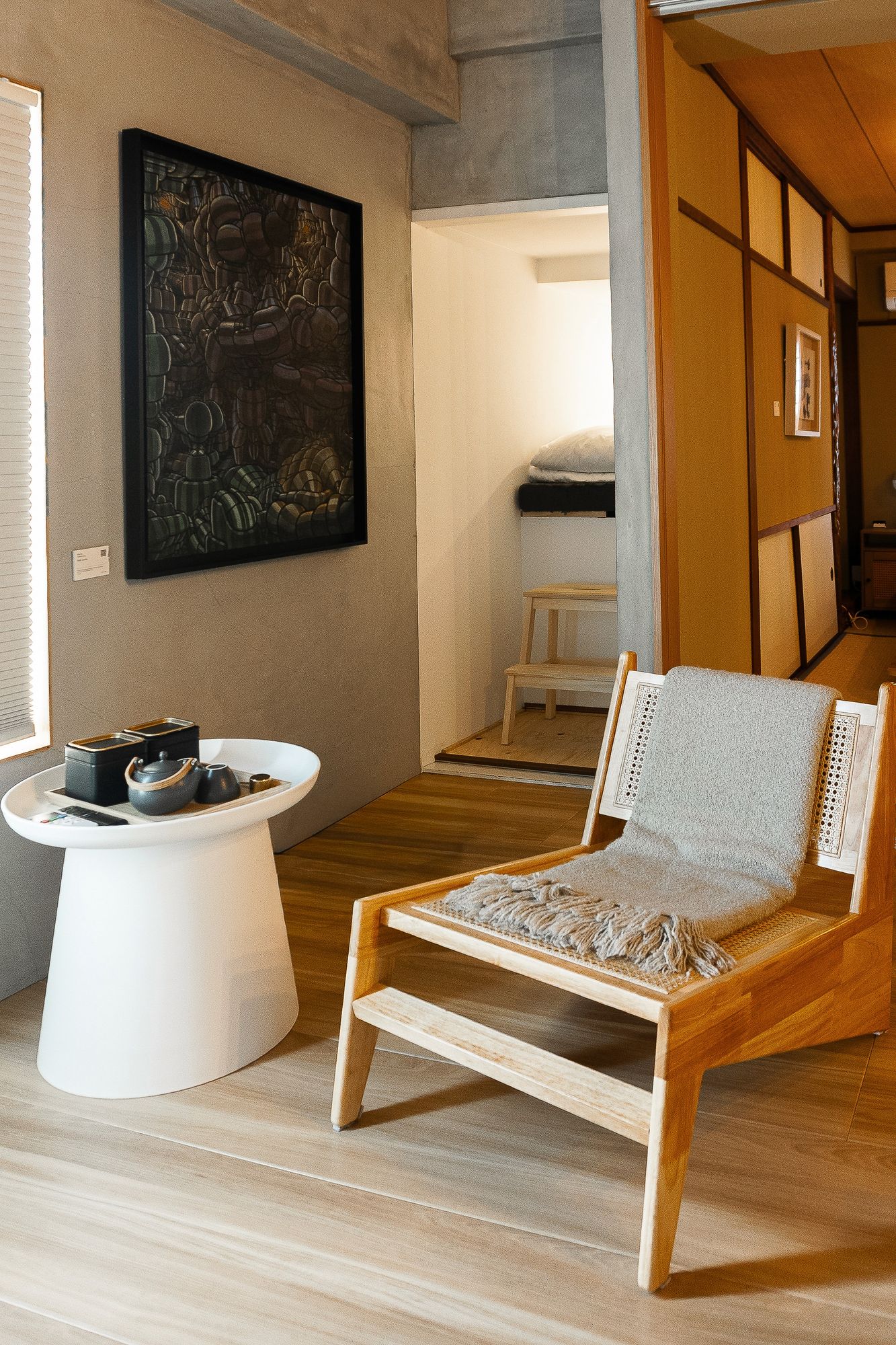 Lounge chair and low table beside a framed artwork