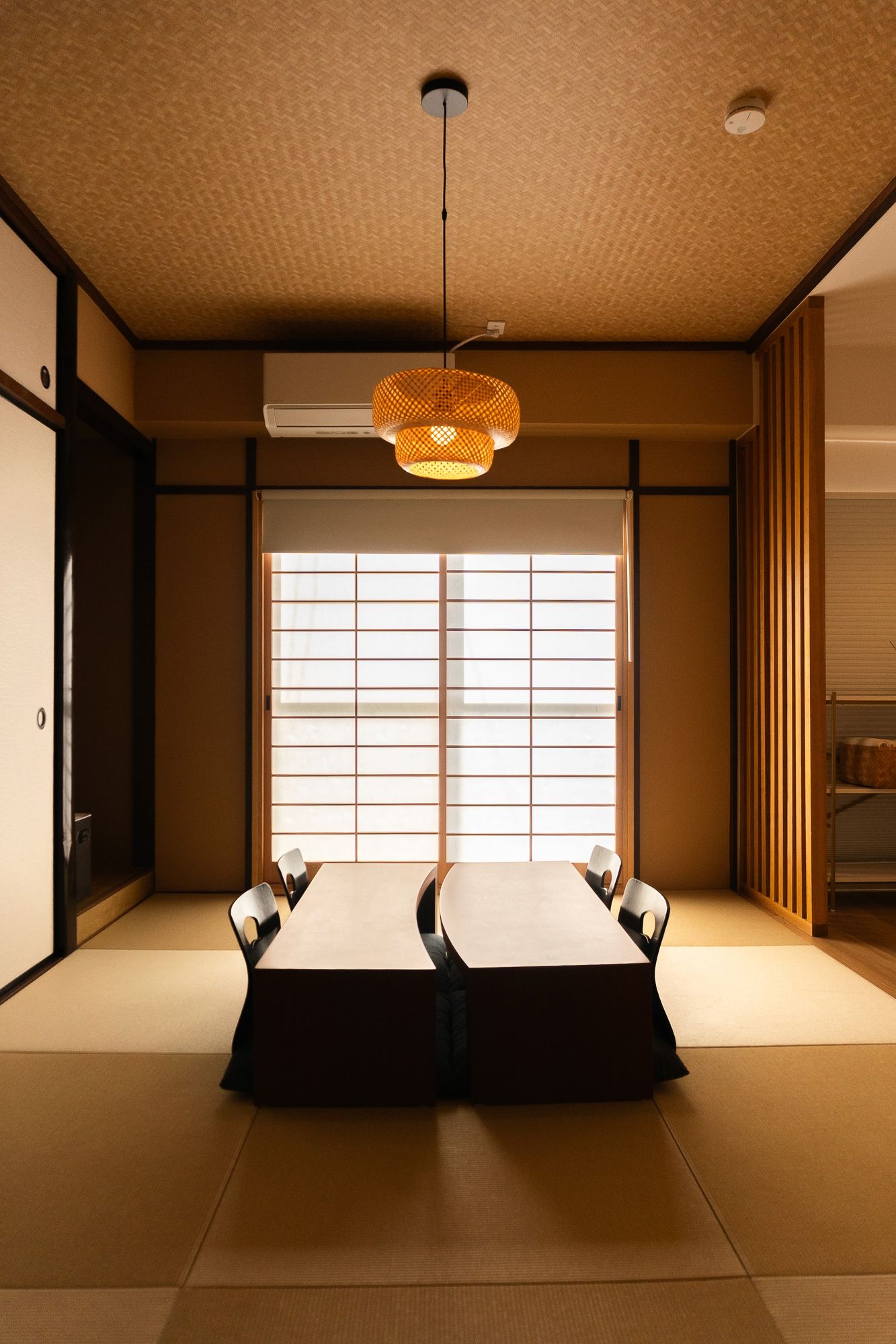 Tatami room with twin futons and an amber pendant